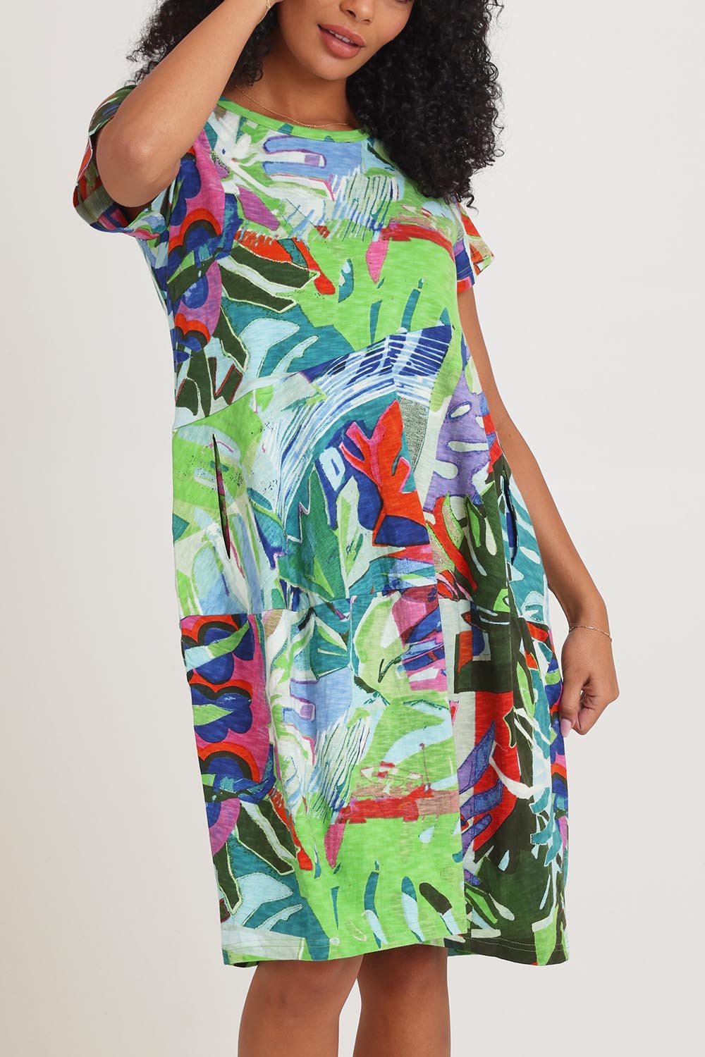 Model Ziara wearing size 10 of the Short Sleeve Bubble Cotton Dress in colour Leavesblue, from the front, cropped image