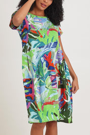 Model Ziara wearing size 10 of the Short Sleeve Bubble Cotton Dress in colour Leavesblue, from the front, cropped image