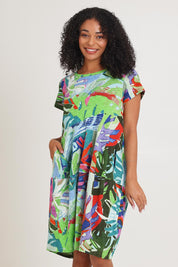 Model Ziara wearing size 10 of the Short Sleeve Bubble Cotton Dress in colour Leavesblue, from the front, cropped image