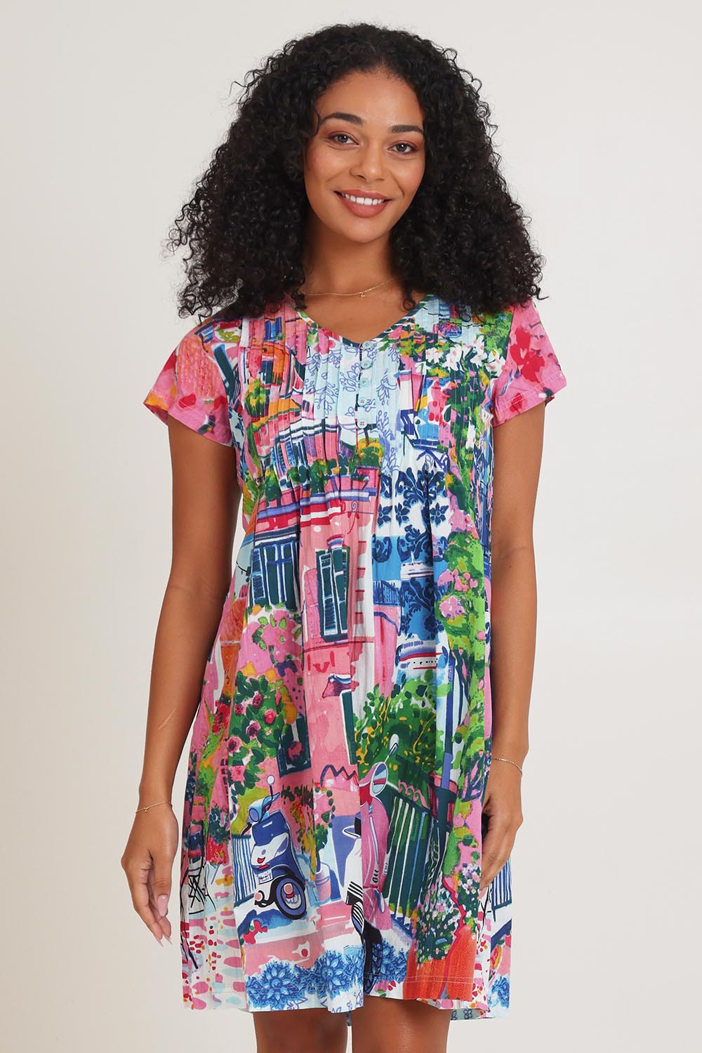 Model Ziara wearing size 10 of the Ezy Fit Cotton Dress in colour Scooter (Pink), from the front, cropped image