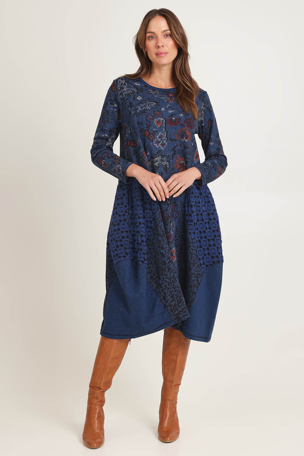 Model Madeline wearing size 10 of the Bubble Dress in colour Tabriz (Blue), from the front, showing the whole outfit