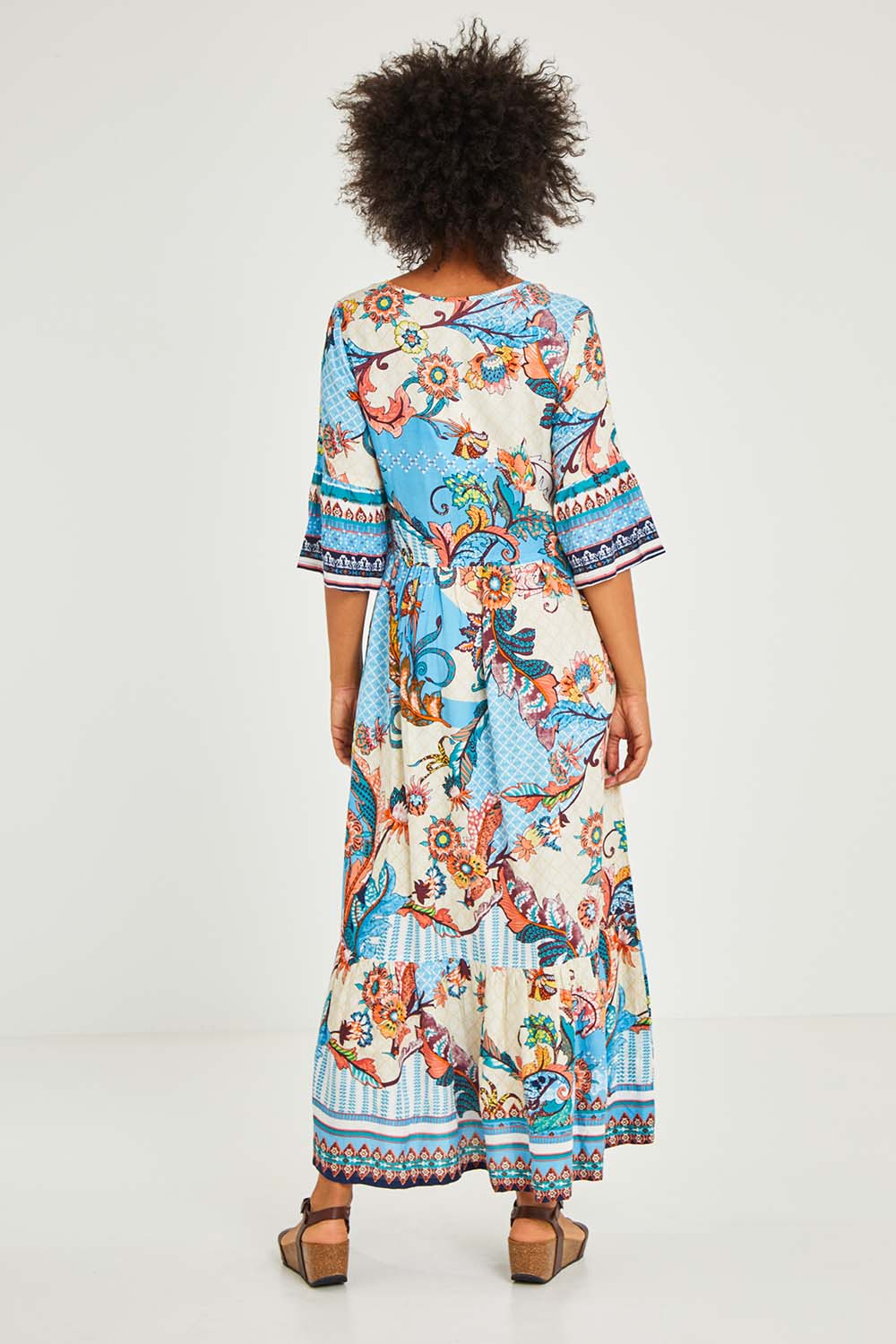 Model Olivia wearing size 10 of the Moster Peak Maxi Dress in colour Print (Blue), from the back