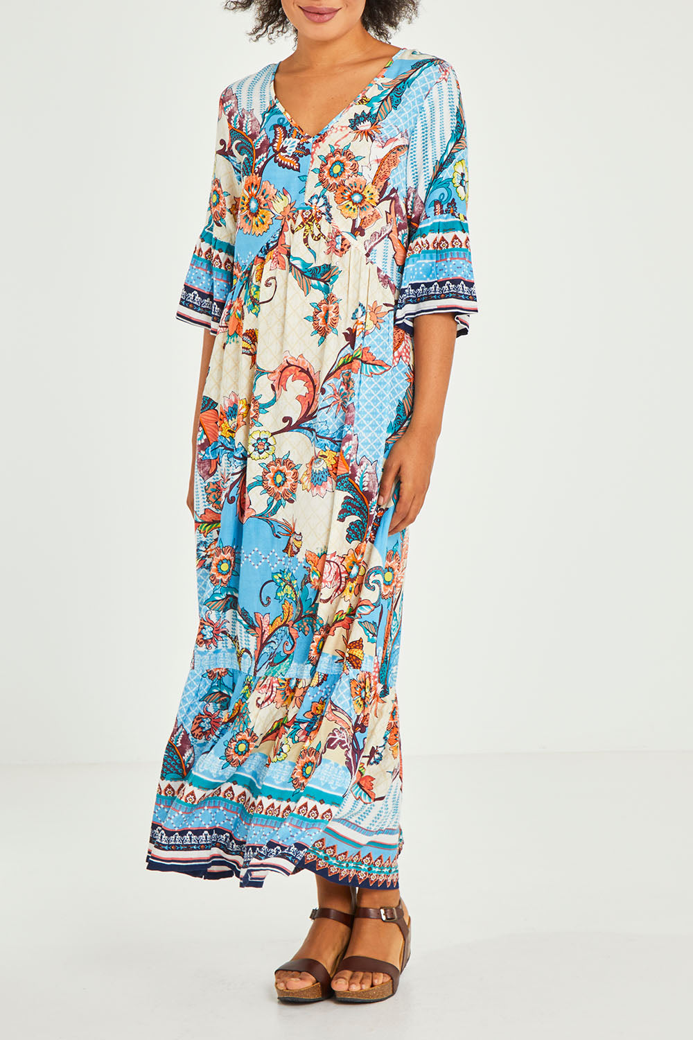 Model Olivia wearing size 10 of the Moster Peak Maxi Dress in colour Print (Blue), from the front, cropped image