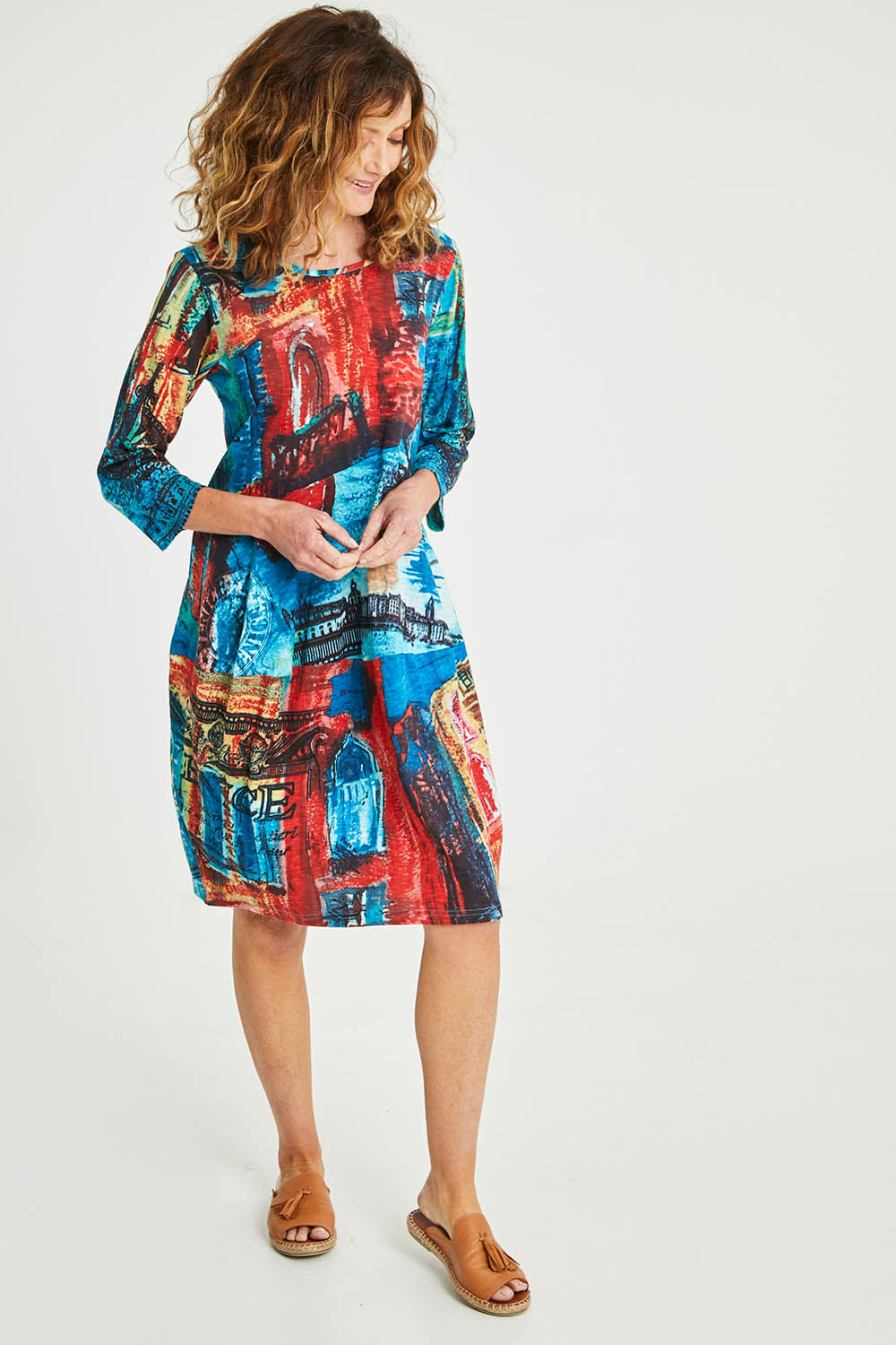 Model Emma wearing size 10 of the Cotton Bubble Dress in colour Venicemult (Blue), from the front, showing the whole outfit
