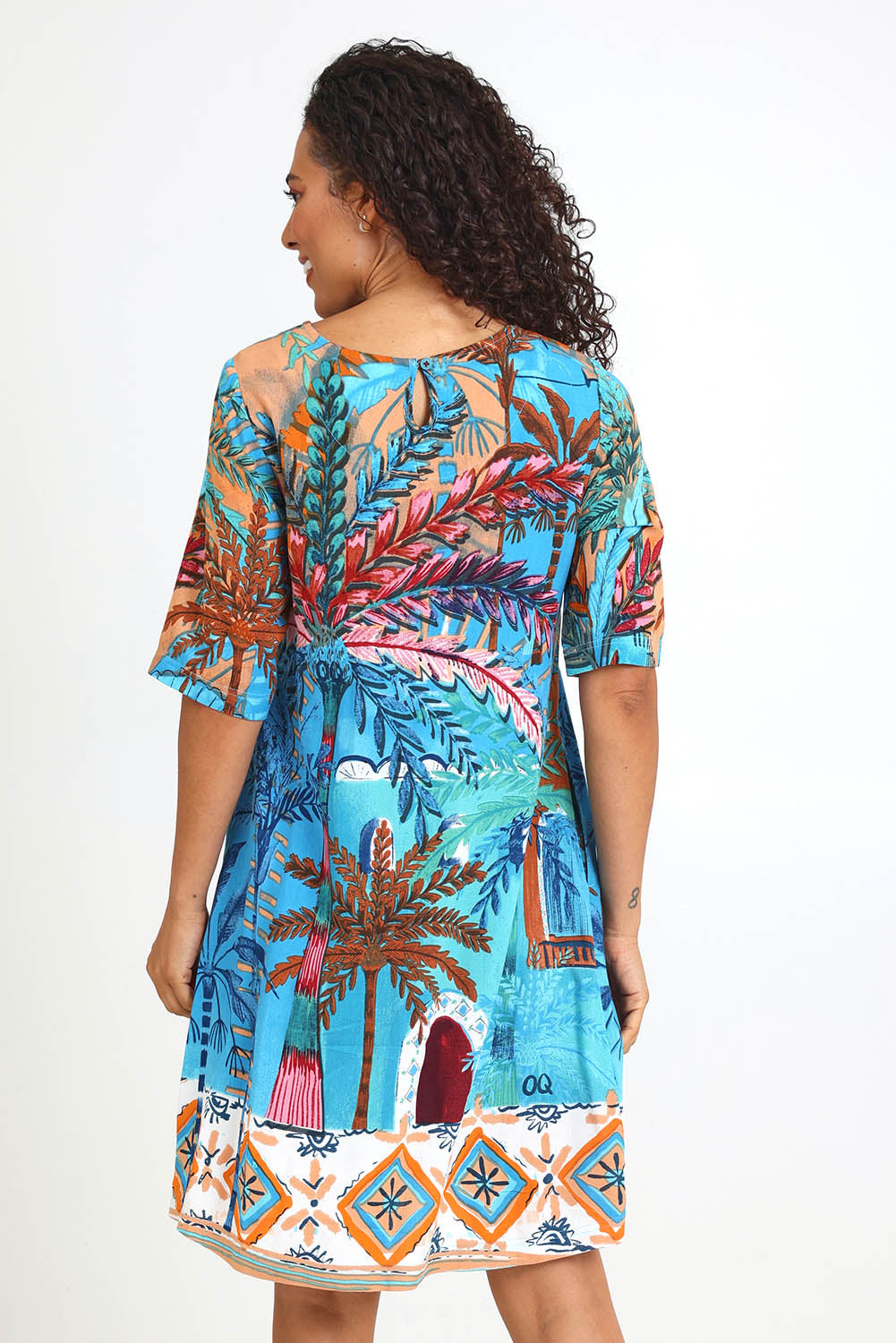 Model Pamelar wearing size 10 of the Contemporary Dress – Print in colour Print, from the back