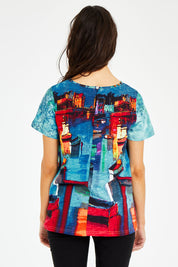 Model Courtney wearing size 10 of the Boats Organic Cotton Tee in colour Boats (Blue), from the back
