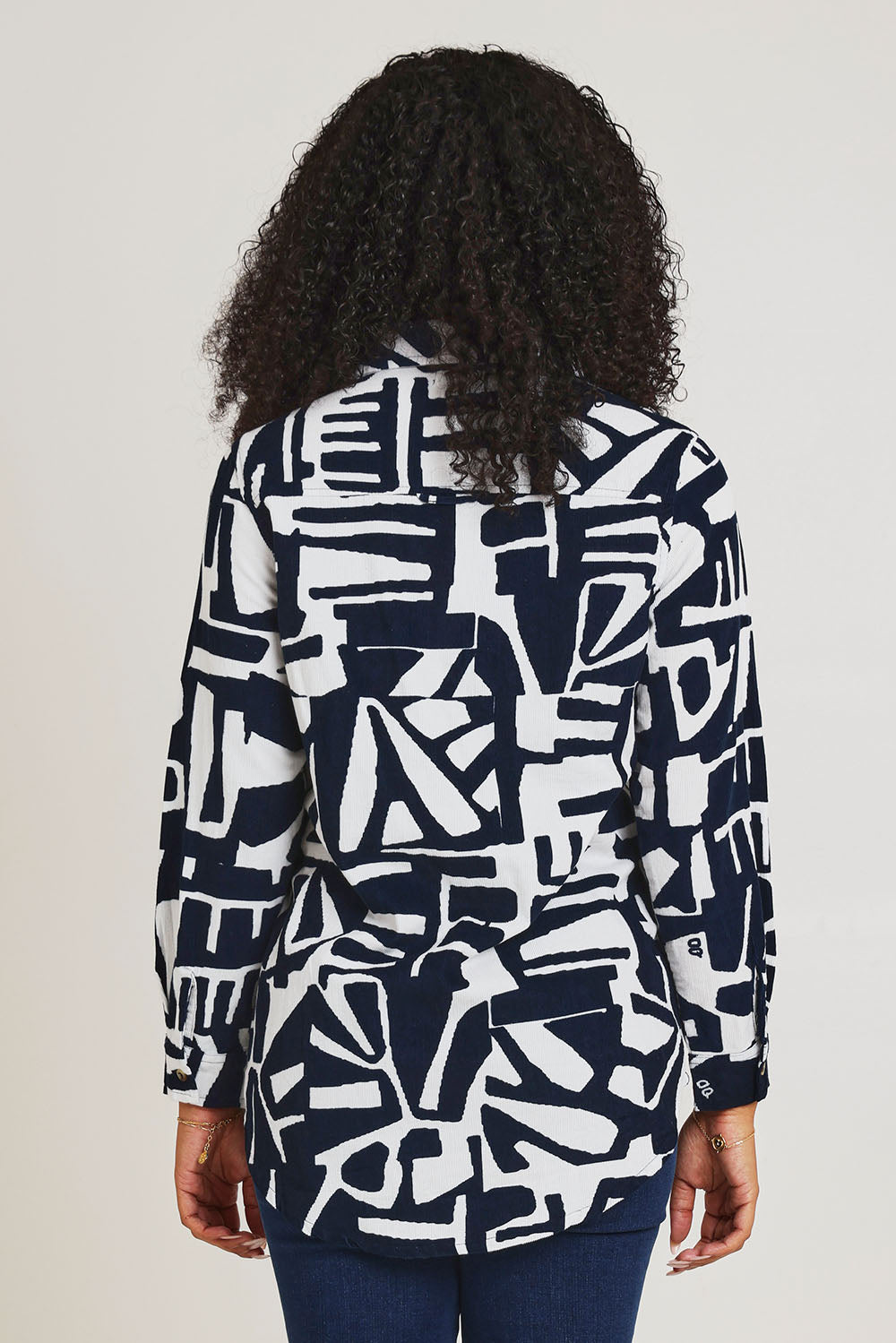 Model Ziara wearing size 10 of the Corduroy Long Shirt in colour Navy (Blue), from the back
