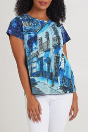 Model Ziara wearing size 10 of the Cotton Crew Contemporary Tin colourShirt - Towerblue, from the front, cropped image