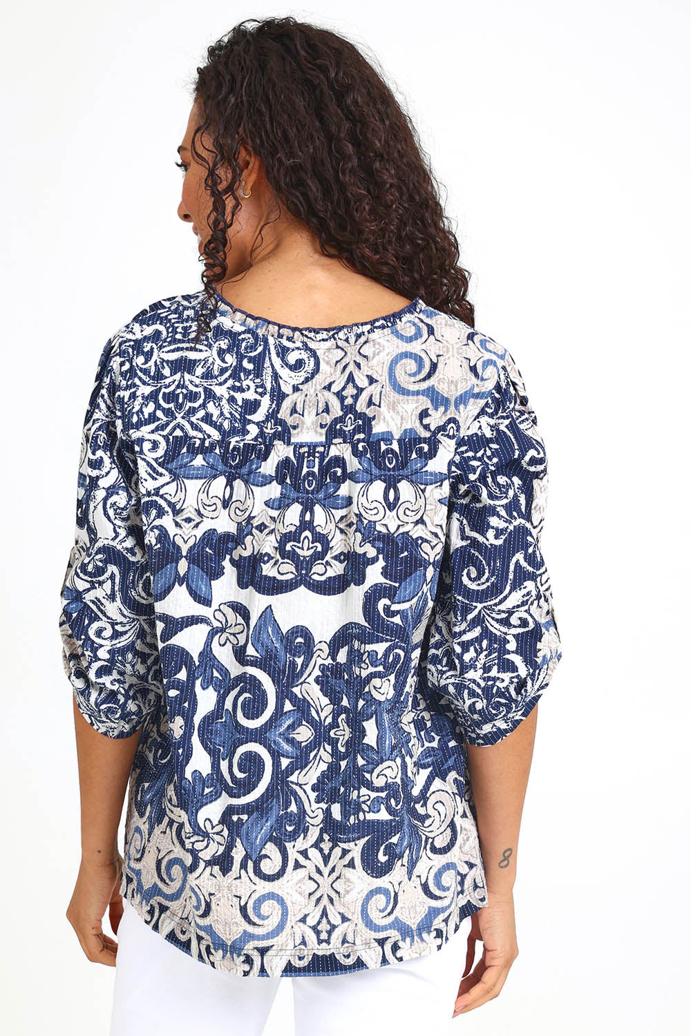 Model Pamelar wearing size 10 of the Frill Neckline Top – Print in colour Print, from the back