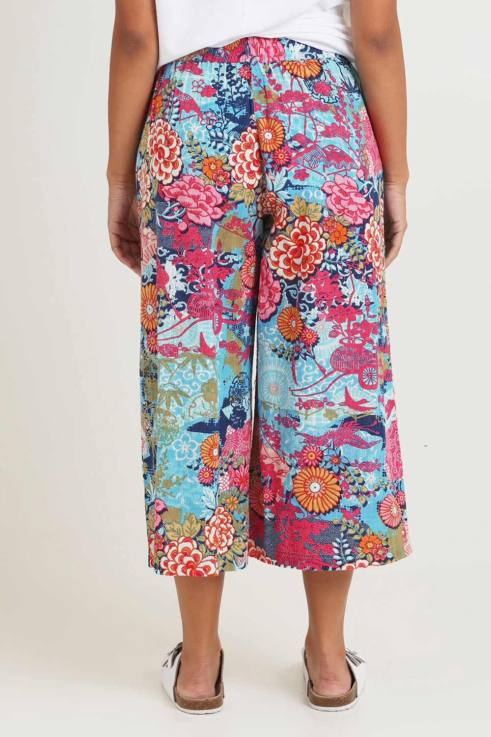 Model Ziara wearing size 10 of the Ikebana Cotton Pant in colour Ikebana, from the back