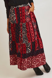 Model Ziara wearing size 10 of the Jolene Cord Skirt in colour Jolene (Red), from the front, cropped image