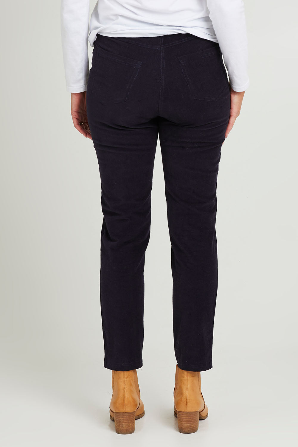 Model Katie wearing size 10 of the Essentials Cord Jeggings in colour Navy (Blue), from the back