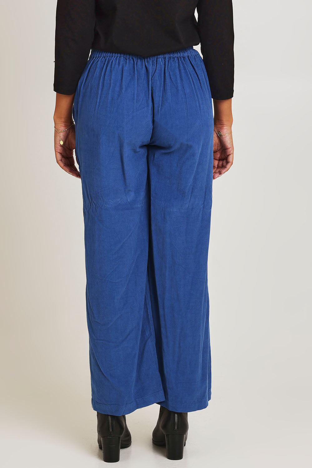 Model Ziara wearing size 10 of the Corduroy Flared Trouser in colour Blue (Blue), from the back