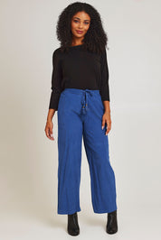 Model Ziara wearing size 10 of the Corduroy Flared Trouser in colour Blue (Blue), from the front, showing the whole outfit