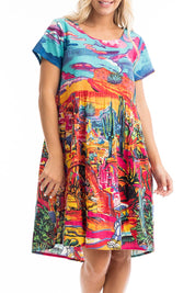 A model wearing the Ocampo Organic Cotton Boxy Ruched Waist Dress in colour Print (Blue), from the front, cropped image