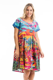 A model wearing the Ocampo Organic Cotton Boxy Ruched Waist Dress in colour Print (Blue), from the front, cropped image