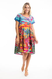 A model wearing the Ocampo Organic Cotton Boxy Ruched Waist Dress in colour Print (Blue), from the front, showing the whole outfit