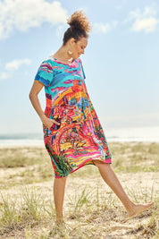 Model Lala wearing size 10 of the Ocampo Organic Cotton Boxy Ruched Waist Dress in colour Print (Blue), from the front, showing the whole outfit