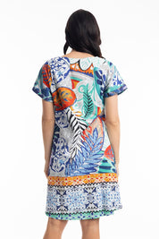 A model wearing the Cayman Organic Cotton Reversible Dress in colour Print (Blue), from the back