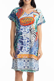 A model wearing the Cayman Organic Cotton Reversible Dress in colour Print (Blue), from the front, cropped image
