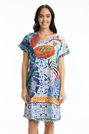 A model wearing the Cayman Organic Cotton Reversible Dress in colour Print (Blue), from the front, cropped image