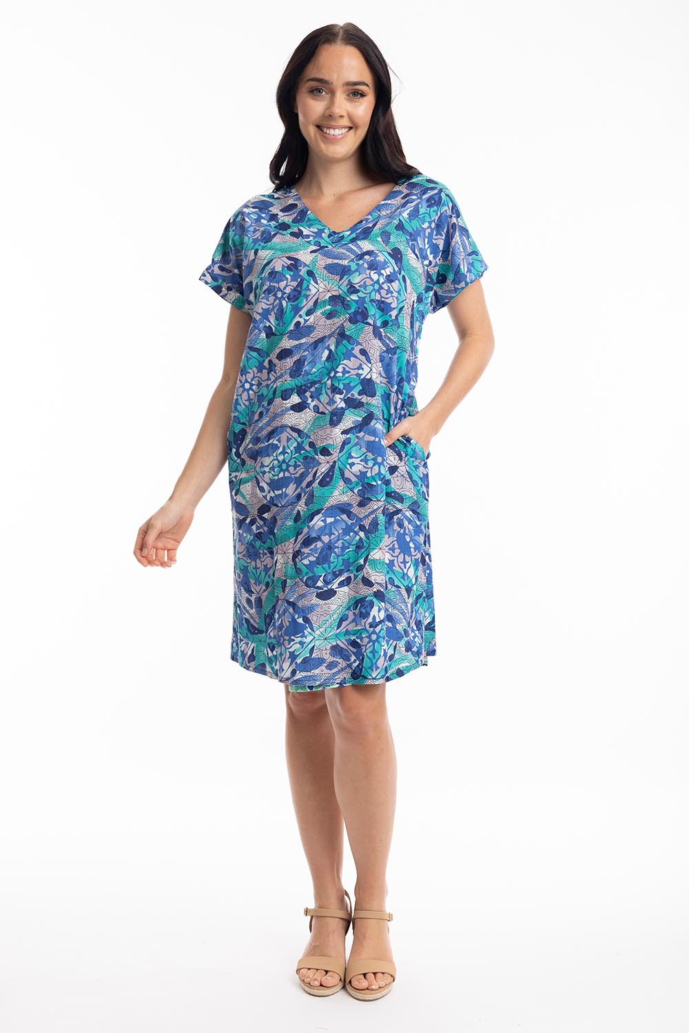 A model wearing the Cayman Organic Cotton Reversible Dress in colour Print (Blue), from the front, showing the whole outfit