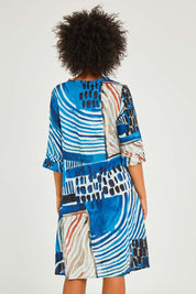 Model Olivia wearing size 10 of the Alberobello Organic Cotton Dress in colour Blue (Blue), from the back