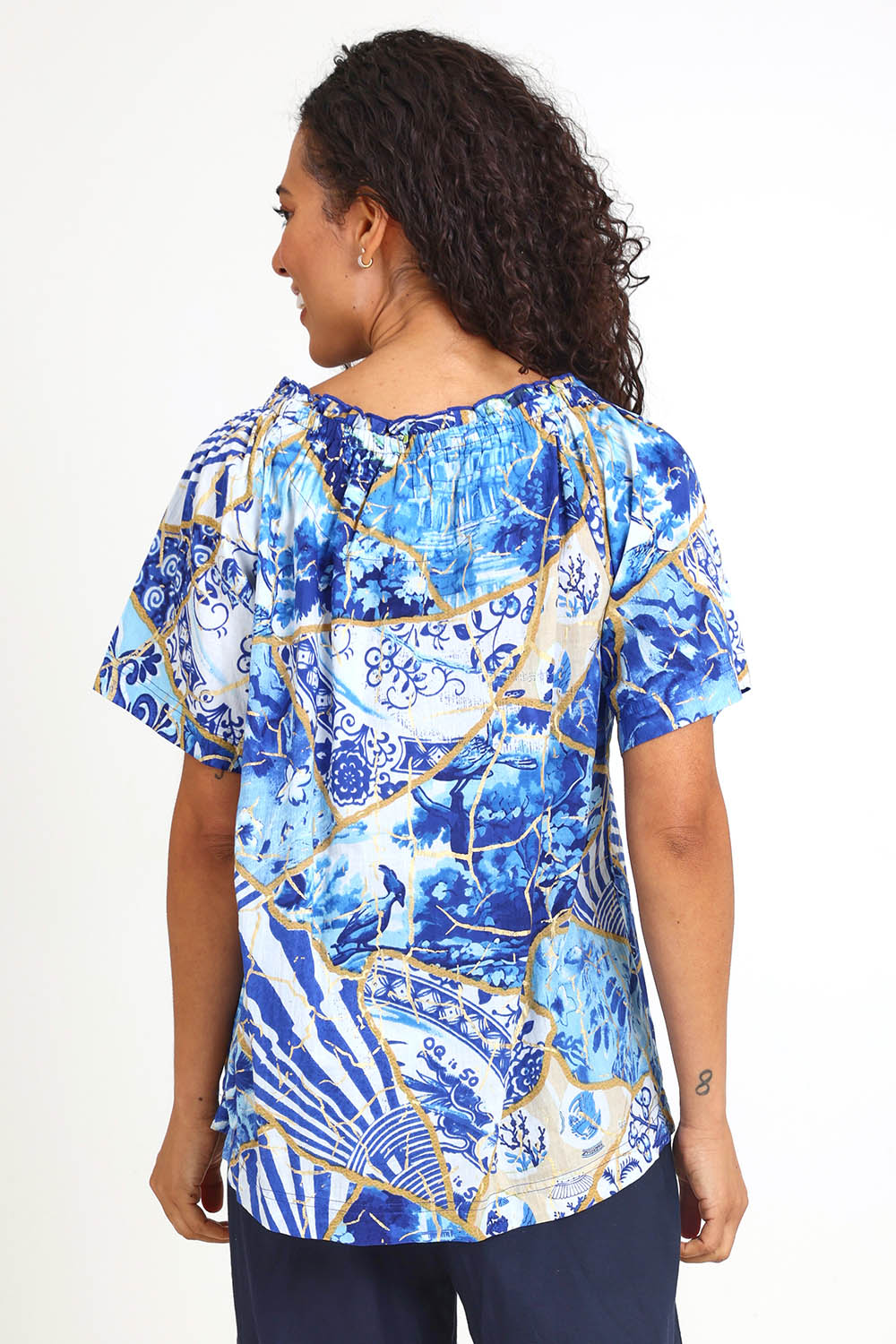 Model Pamelar wearing size 10 of the Frill Neckline Top – Print in colour Print, from an angle