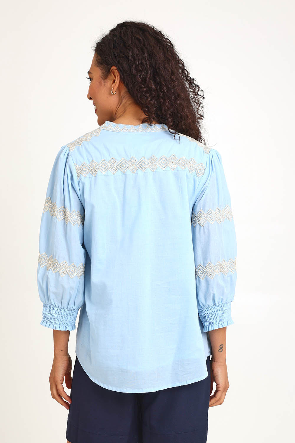 Model Pamelar wearing size 10 of the Essentials Embroidered Cotton Top - Sky in colour Sky, from an angle