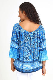 Model Pamelar wearing size 10 of the Boho Tassel Top – Blue in colour Blue, from an angle