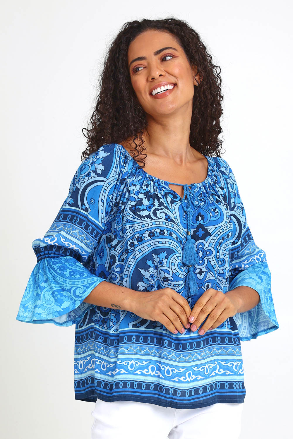 Model Pamelar wearing size 10 of the Boho Tassel Top – Blue in colour Blue, in a cropped view