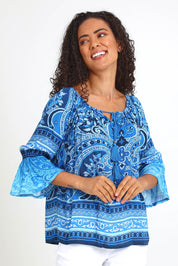 Model Pamelar wearing size 10 of the Boho Tassel Top – Blue in colour Blue, in a cropped view