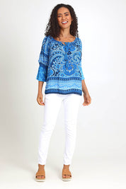 Model Pamelar wearing size 10 of the Boho Tassel Top – Blue in colour Blue, from the front