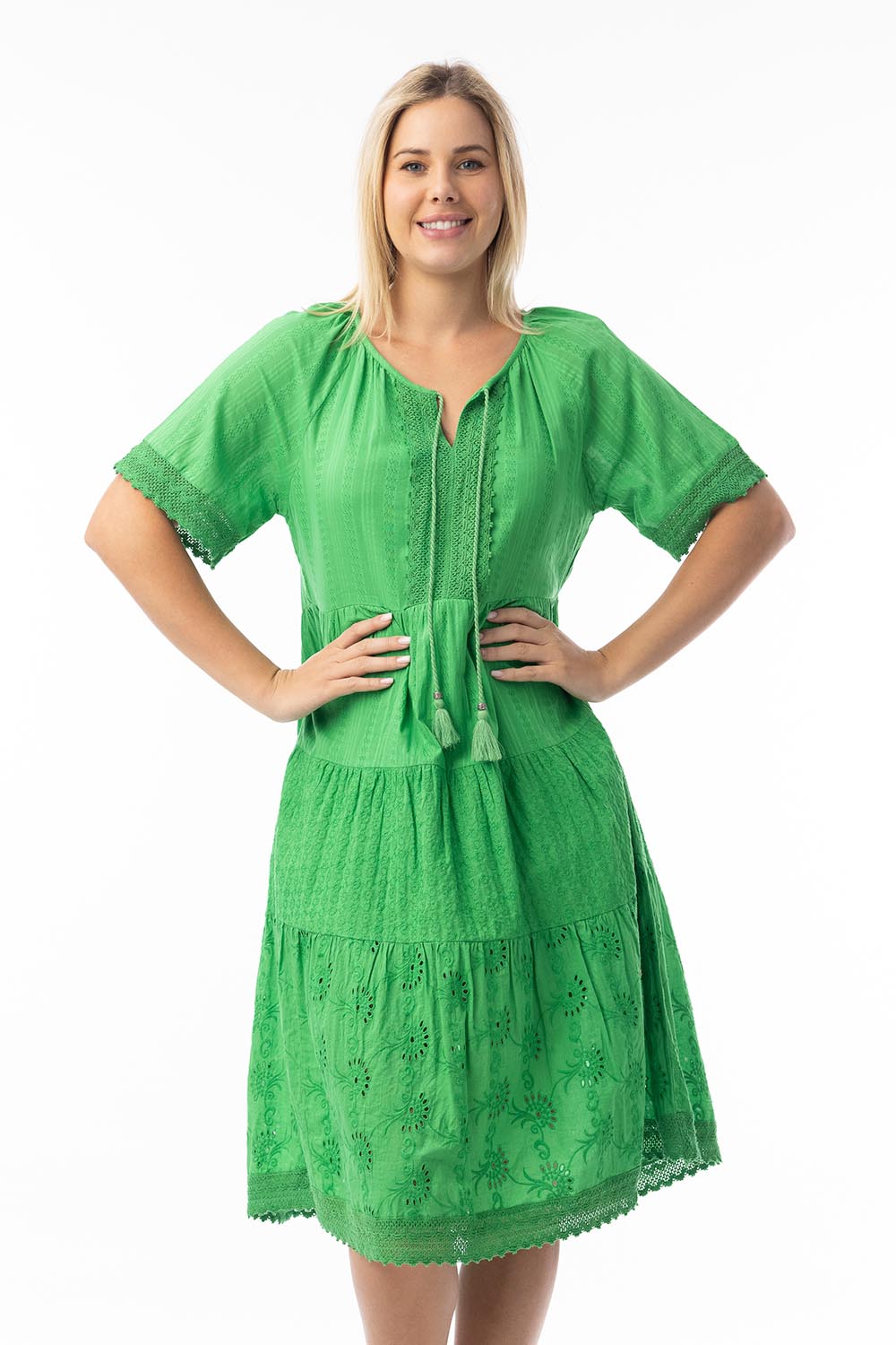 A model wearing the Essential Broderie Layers Cotton Dress in colour Green (Green), from the front, cropped image