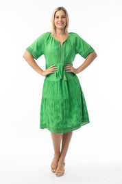 A model wearing the Essential Broderie Layers Cotton Dress in colour Green (Green), from the front, showing the whole outfit