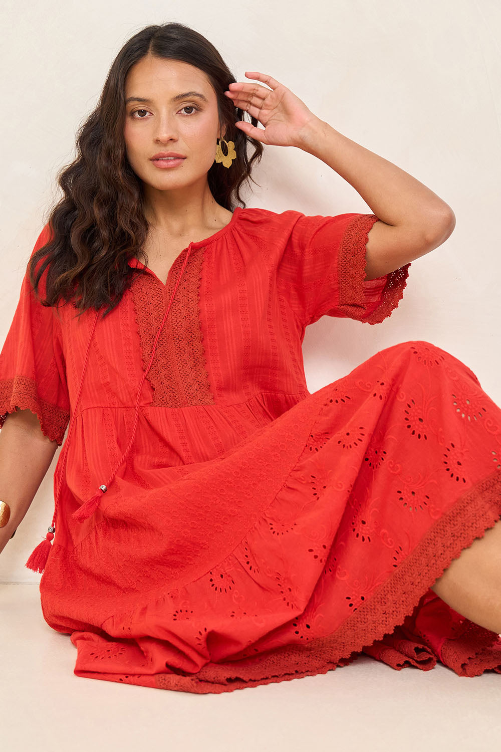 Model Tahnee wearing size 10 of the Essential Broderie Layers Cotton Dress in colour Red (Red), from the front, showing the whole outfit