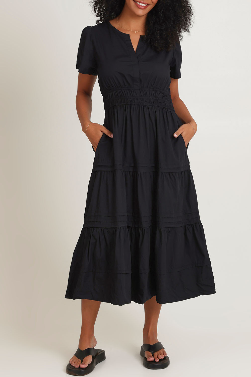 Model Ziara wearing size 10 of the Essentials Organic Cotton Poplin Maxi Ruched Waist Dress in colour Black (Black), from the front, cropped image