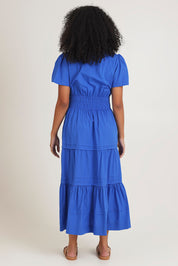 Model Ziara wearing size 10 of the Essentials Organic Cotton Poplin Maxi Ruched Waist Dress in colour Blue (Blue), from the back