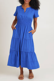 Model Ziara wearing size 10 of the Essentials Organic Cotton Poplin Maxi Ruched Waist Dress in colour Blue (Blue), from the front, cropped image