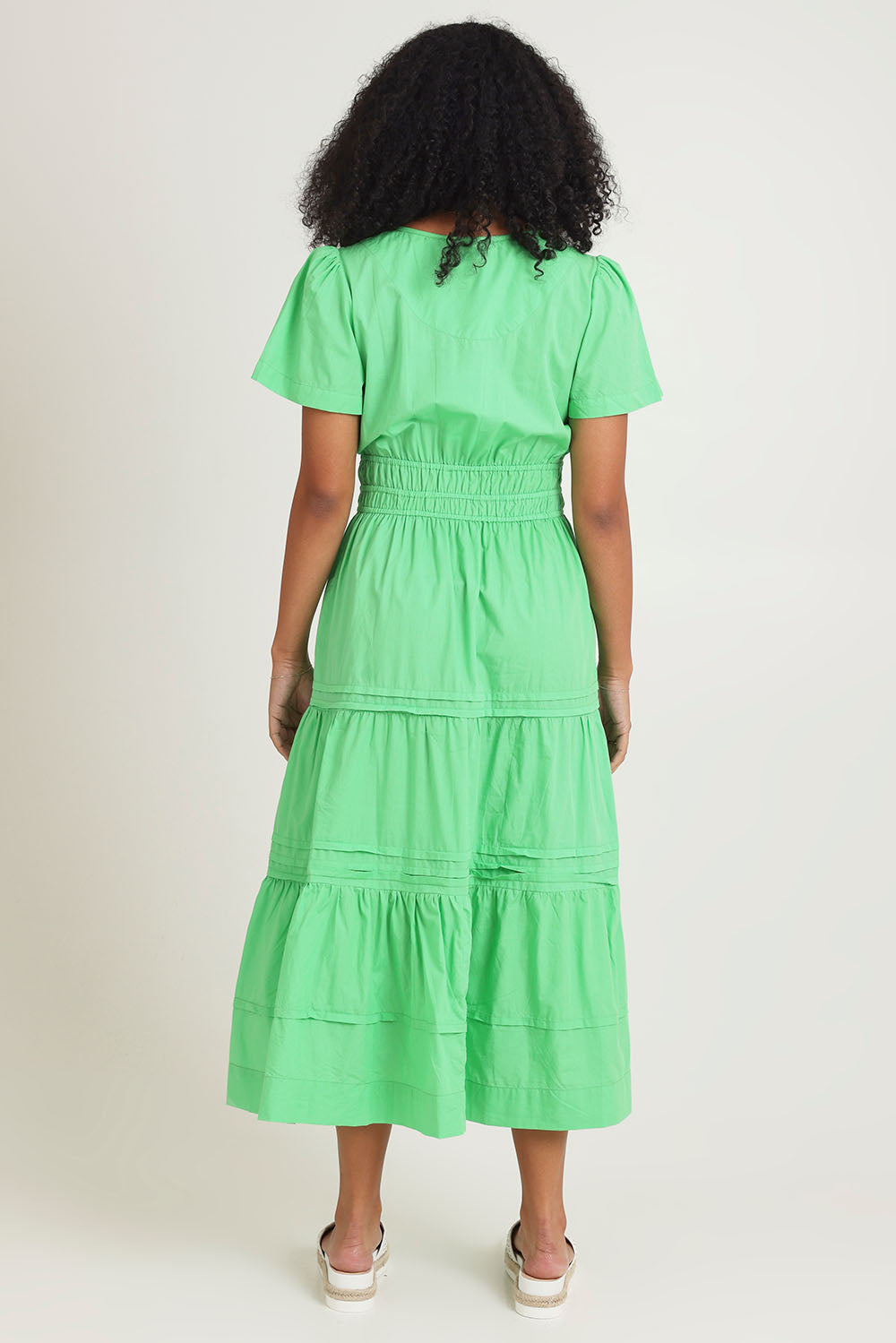 Model Ziara wearing size 10 of the Essentials Organic Cotton Poplin Maxi Ruched Waist Dress in colour Green (Green), from the back