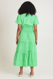 Model Ziara wearing size 10 of the Essentials Organic Cotton Poplin Maxi Ruched Waist Dress in colour Green (Green), from the back