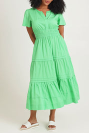 Model Ziara wearing size 10 of the Essentials Organic Cotton Poplin Maxi Ruched Waist Dress in colour Green (Green), from the front, cropped image