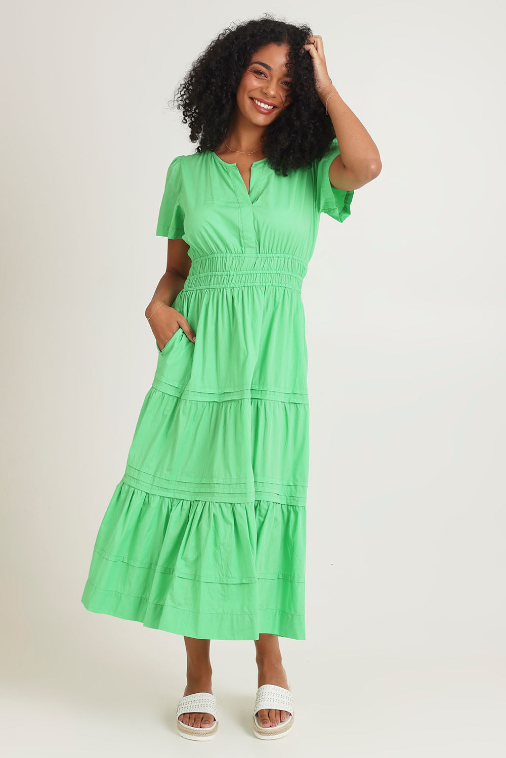 Model Ziara wearing size 10 of the Essentials Organic Cotton Poplin Maxi Ruched Waist Dress in colour Green (Green), from the front, showing the whole outfit