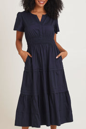 Model Ziara wearing size 10 of the Essentials Organic Cotton Poplin Maxi Ruched Waist Dress in colour Navy (Blue), from the front, cropped image