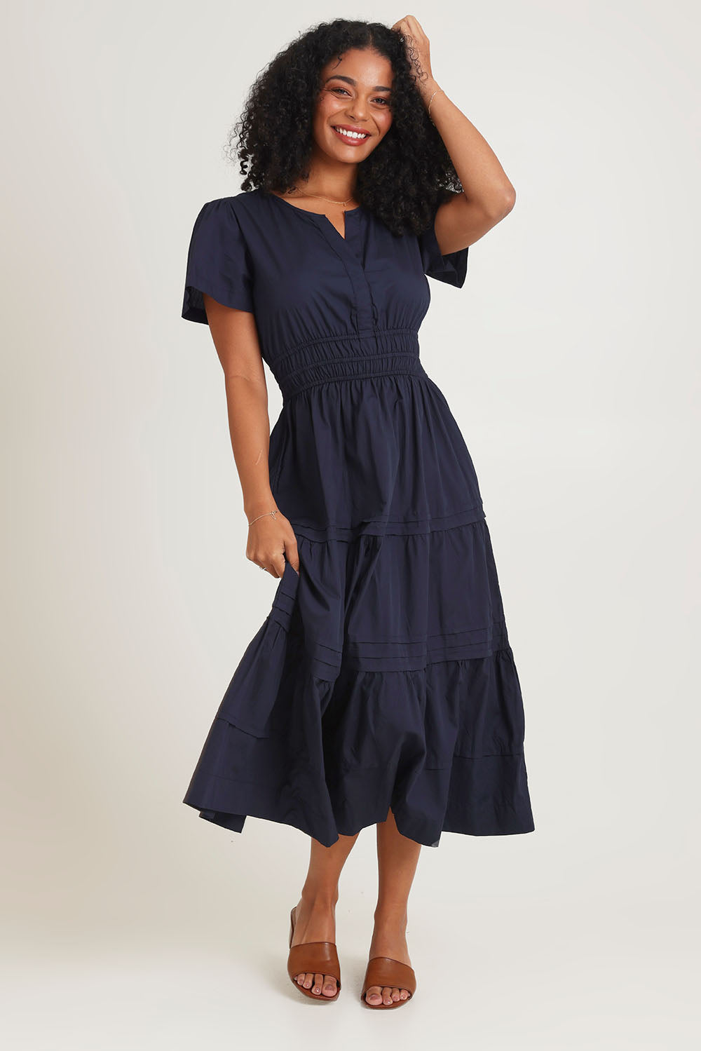 Model Ziara wearing size 10 of the Essentials Organic Cotton Poplin Maxi Ruched Waist Dress in colour Navy (Blue), from the front, showing the whole outfit