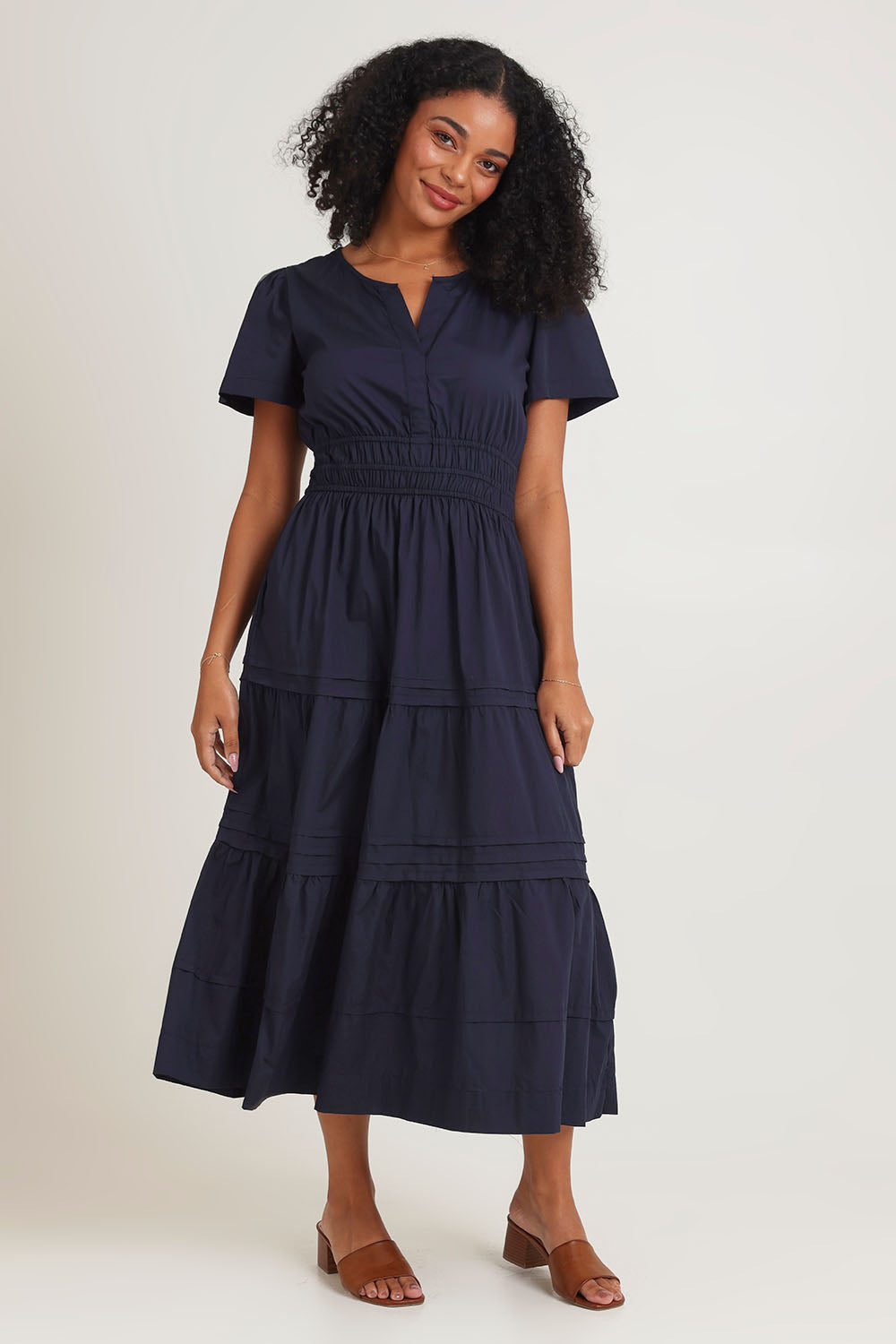 Model Ziara wearing size 10 of the Essentials Organic Cotton Poplin Maxi Ruched Waist Dress in colour Navy (Blue), from the front, showing the whole outfit