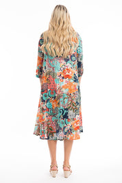 A model wearing the Yakushima Organic Cotton Patch Dress in colour Print (Blue), from the back