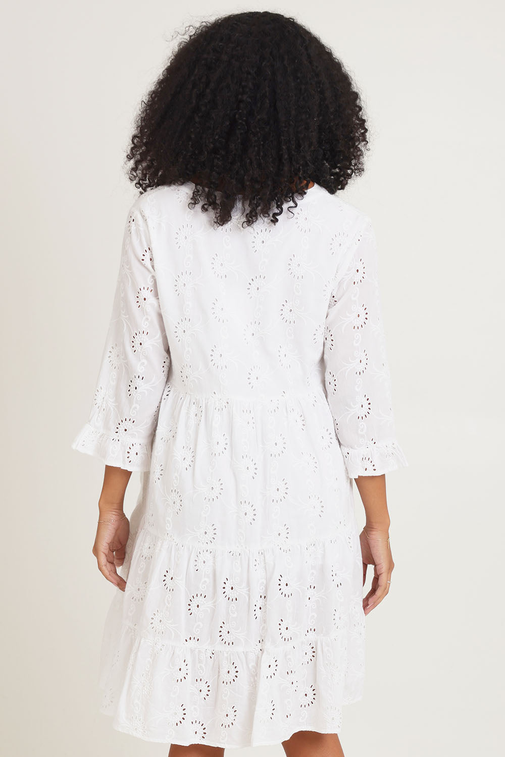 Model Ziara wearing size 10 of the Essentials Frill Hem Broderie Cotton Dress in colour White (White), from the back