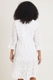 Model Ziara wearing size 10 of the Essentials Frill Hem Broderie Cotton Dress in colour White (White), from the back