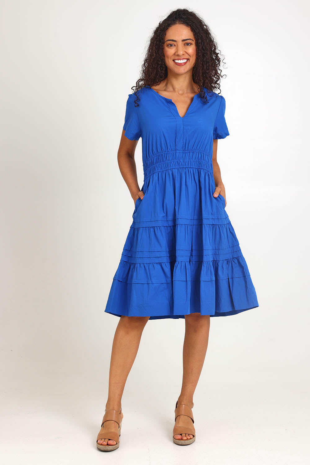 Model Pamelar wearing size 10 of the Essentials Poplin Short Sleeve Cotton Short Dress - Blue in colour Blue, from the front